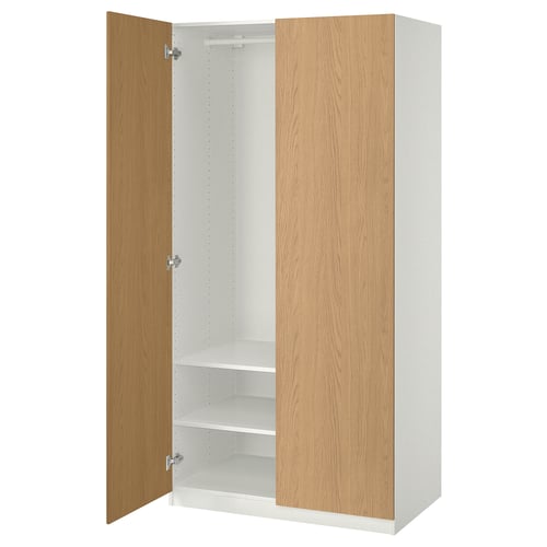 A white PAX wardrobe with wooden doors open, revealing adjustable shelves.