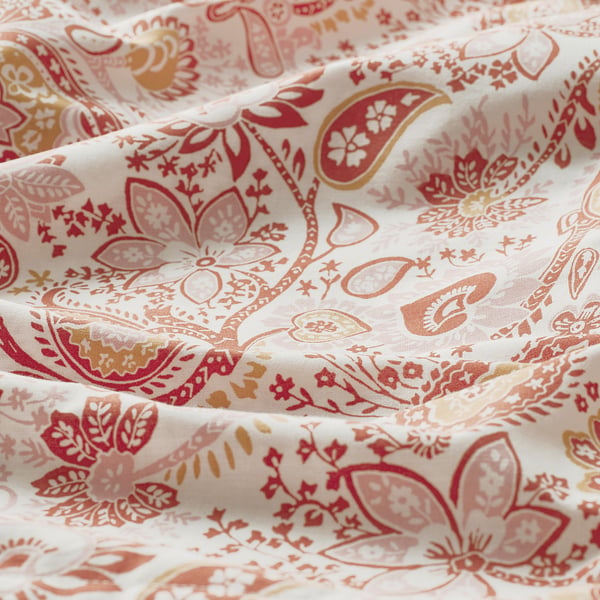 Paisley-patterned pillowcase, soft cotton-viscose blend, intricate red-gold designs, fine sheen visible.