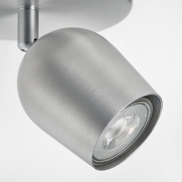Silver modern adjustable spotlight with smooth finish and reflective bulb housing.