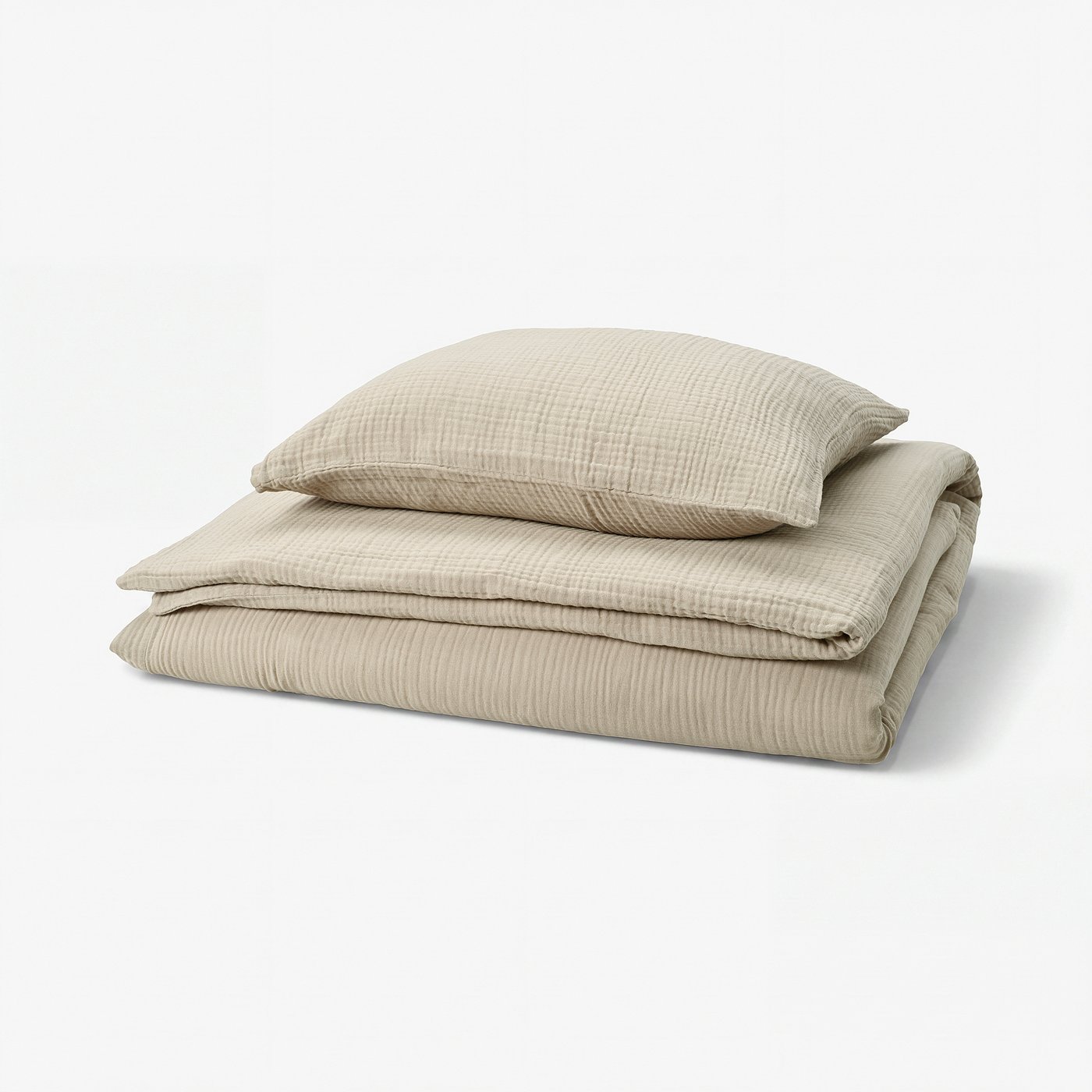 A folded beige SCHERSMIN duvet set with envelope pillowcases, made of soft, breathable organic cotton.