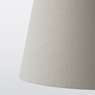 Close-up of beige textured lamp shade showing quality fabric.