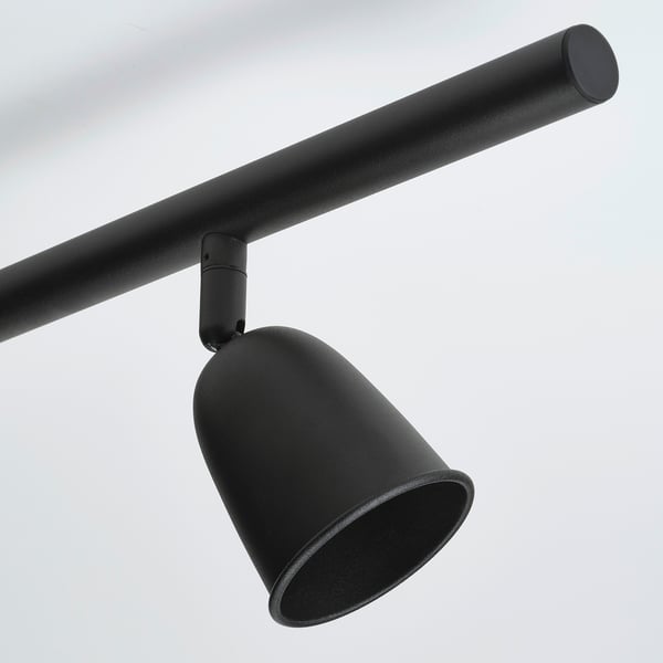Black adjustable ceiling spotlight with cylindrical rod and textured shade.