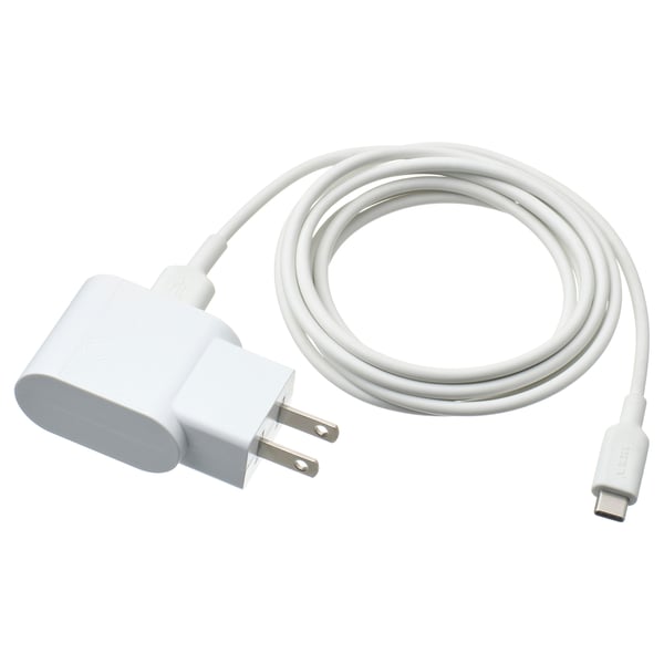 Small white usb charger with 2-prong plug and coiled white usb cable.