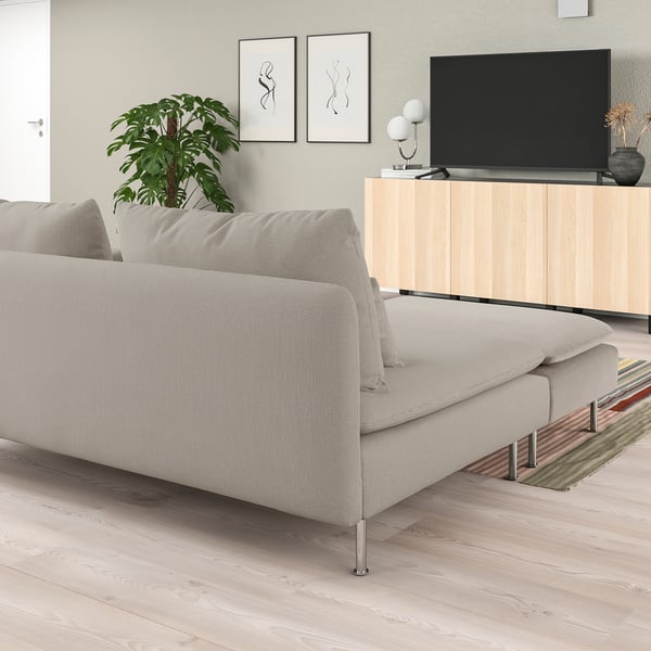 Modern minimalist living room with light-colored SÖDERHAMN sofa, beige upholstery, light wood floors, tv stand, and greenery.