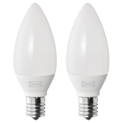 Two white ikea SOLHETTA led light bulbs with e12 base, frosted covers, standing upright.