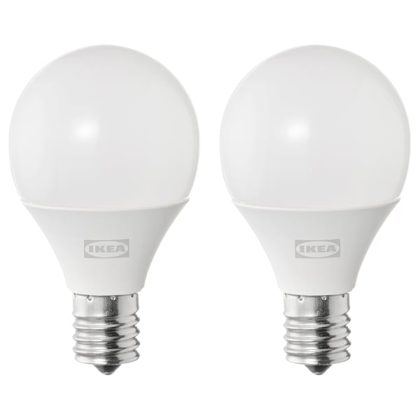 Two ikea white spherical led light bulbs with metallic base.
