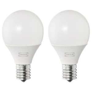 Two ikea white spherical led light bulbs with metallic base.