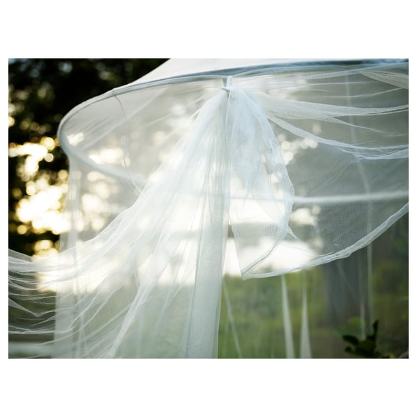 White hanging net canopy, sheer fabric, circular design, outdoor relaxation.