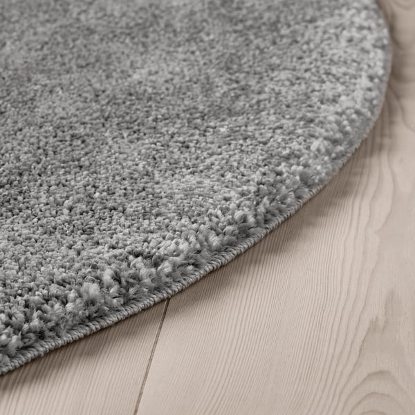 Round grey rug, wooden floor, soundproof, eco yarn.