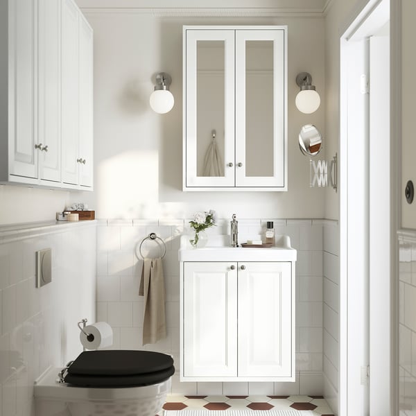 Modern bathroom with TÄNNFORSEN cabinet, sink, toilet, tall mirror & side lights.