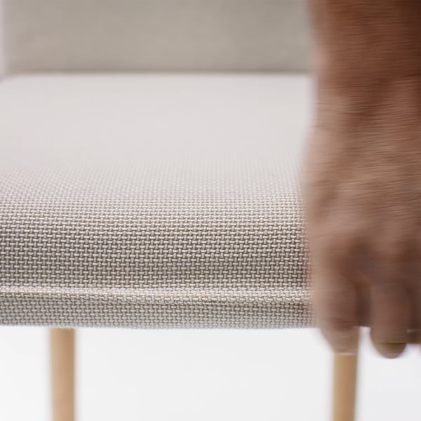 Close-up of woven fabric chair, showcasing intricate weave and plush texture, indicating high-quality comfort and durability.