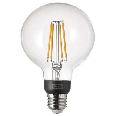TRÅDFRI smart led bulb, glowing yellow, round glass shape.