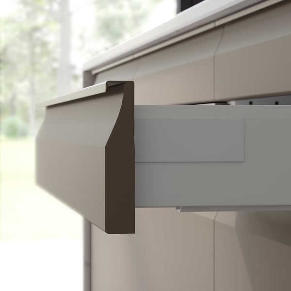 Modern kitchen cabinets in matt beige with sleek, integrated handles.