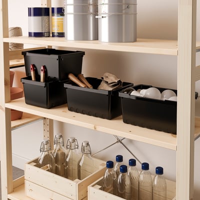 Shelf with three boxes: tools, cloth/bulbs, spheres. Crate holds bottles.