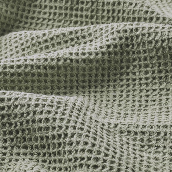 Soft, woven towel with earthy green tones, showcasing texture and quality.