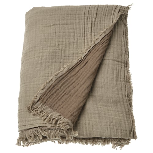 VALLKRASSING beige cotton throw; textured, fringed edges, draped.