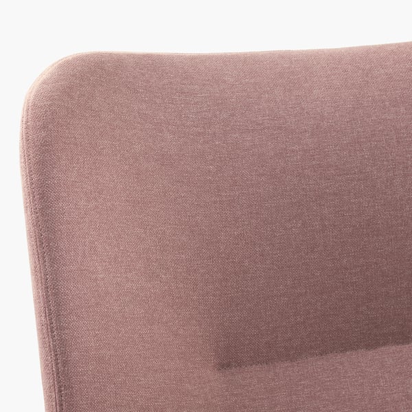Close-up of luxurious, soft, upholstered armchair in rich velvet, showcasing high-quality fabric and craftsmanship.