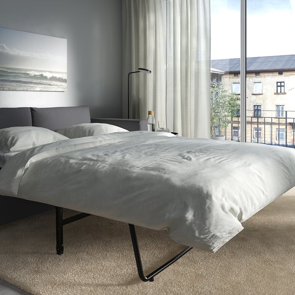 Bedroom with VIMLE sofa-bed, featuring thick mattress, near large window.