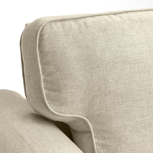 Sofa with smooth, plush beige fabric. Curved back and armrests, stitched lines for style.