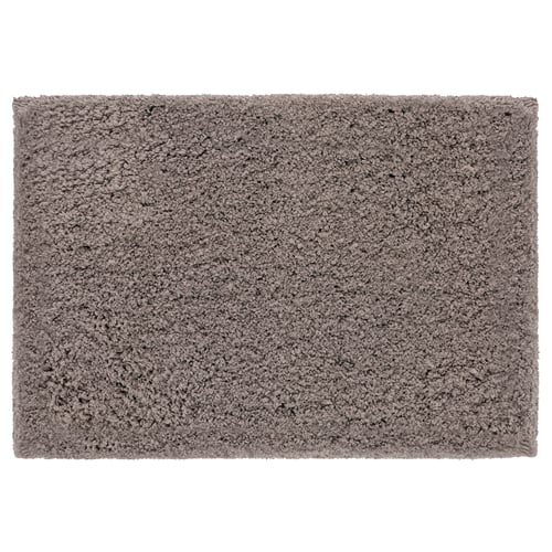 A grey rectangular bath mat, named ALMTJÄRN, made of soft polyester microfibre and latex backing.