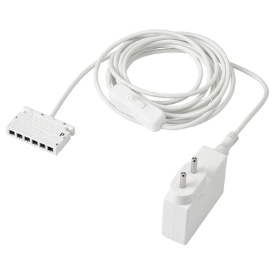 A white ANSLUTA power cord with a 6-way adapter and a power plug, designed for controlling multiple lights with a single switch.