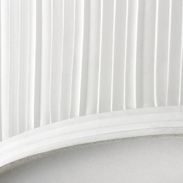 Modern, minimalist lamp with sleek white shade, emitting soft diffused light.