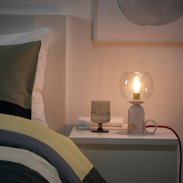 Modern kerosene-style lamp on bedside table, warm mood light, small abs plastic & glass design, dimmable.