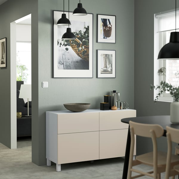 Modern dining room with BESTÅ sideboard, art, bowl, and plant.