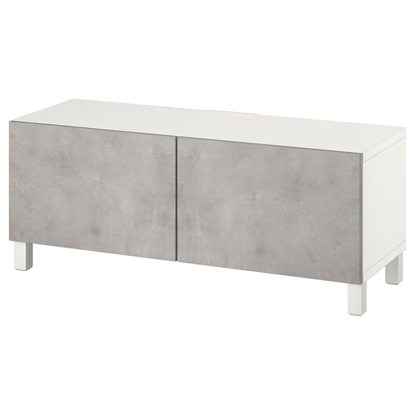 A white and concrete-colored BESTÅ tv bench with two doors and adjustable shelves.