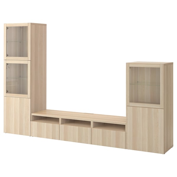 Wooden BESTÅ tv unit with drawers, shelves, and glass-door cabinets.