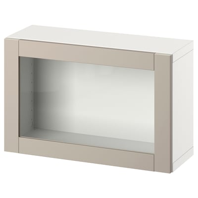 A white BESTÅ storage unit with a beige frame and glass door. Its rectangular and simple in design, perfect for organising items at home.