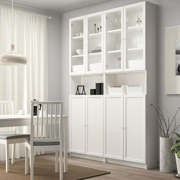 Modern white BILLY storage. Tall with glass doors, holds dishes. Fits dining room, sleek and clean.