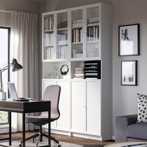 Modern home office with BILLY bookcase, laptop desk, and sofa.