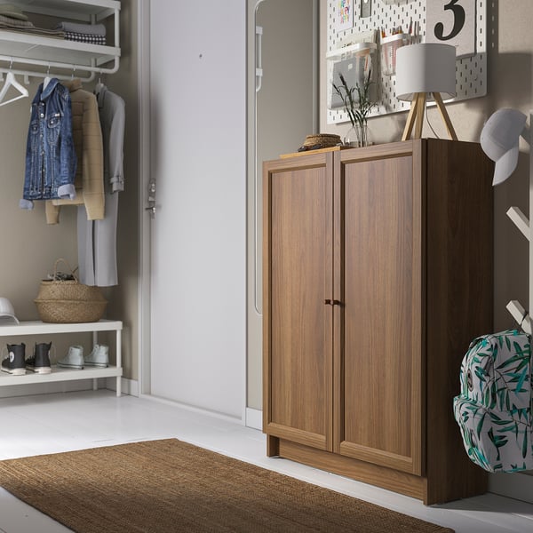 BILLY bookcase in hallway with lamp, closet, and backpack hook.