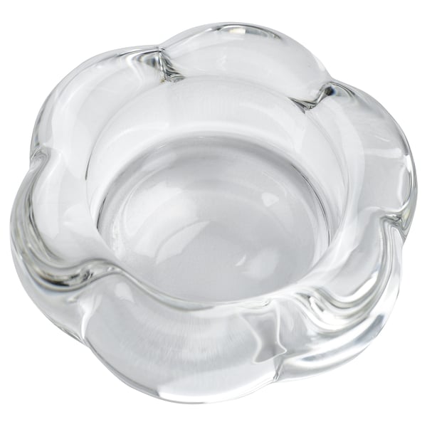 Clear glass flower-shaped tealight holder, modern design, sleek surface, petal edges, elegant look.