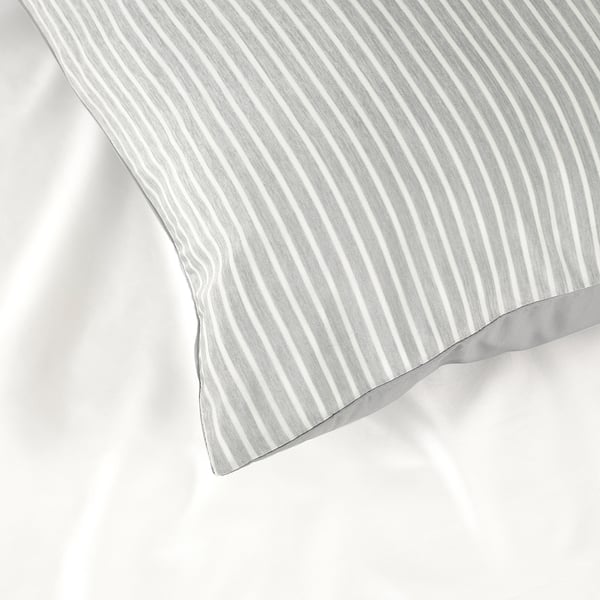 Close-up of a BRANDLILJA pillowcase with thin white stripes. Textured fabric hinting at cool, breathable material.