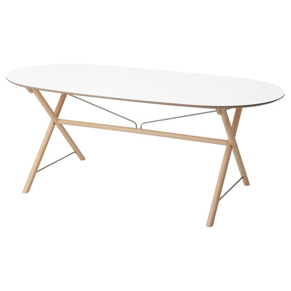 The DALSHULT table a clear glass top, light wood legs, and stainless steel supports.