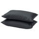 Two dark grey rectangular pillows stacked neatly, smooth texture, simple design.