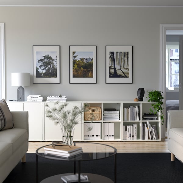 Modern living room with EKET storage, sofas, and glass coffee table.