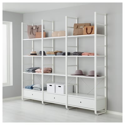 White ELVARLI storage system with shelves, drawers, purses, hats, and folded clothes.