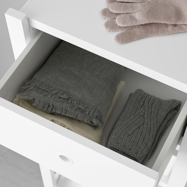 White drawer storing neatly folded clothes, demonstrating easy access and organisation.