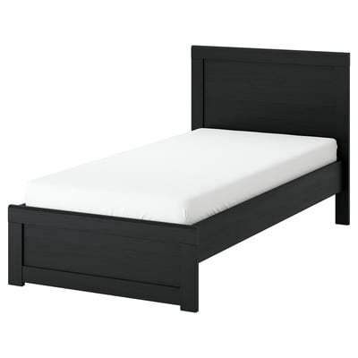 Black fågelfjälet bed with white mattress. Modern wooden design.