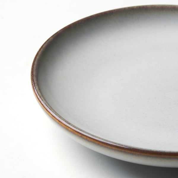 White plate with brown rim.