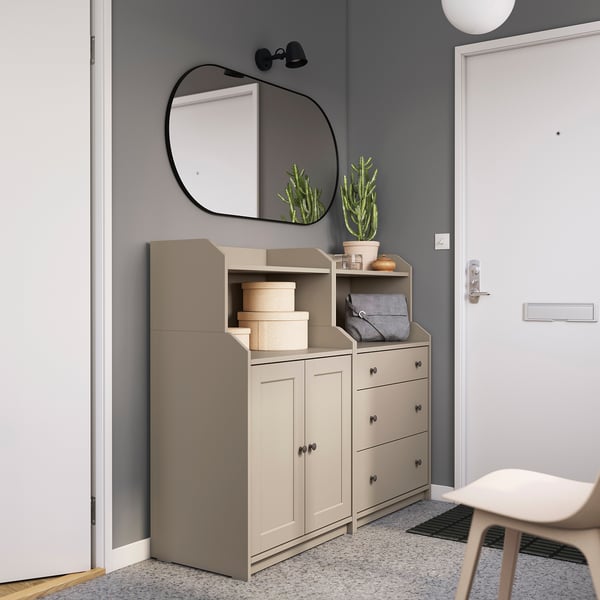 Modern entryway with HAUGA light grey storage units, mirror, and plant.