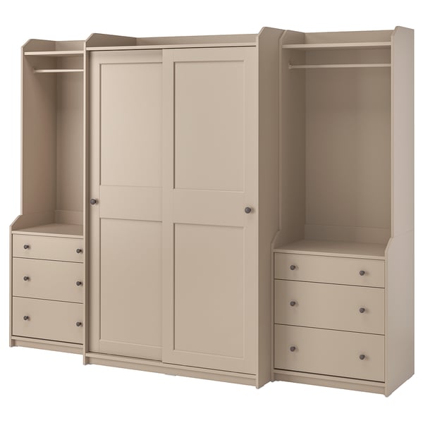 An ikea HAUGA beige wardrobe set with sliding doors and open drawers, made of particleboard and fiberboard.