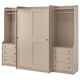 An ikea HAUGA beige wardrobe set with sliding doors and open drawers, made of particleboard and fiberboard.