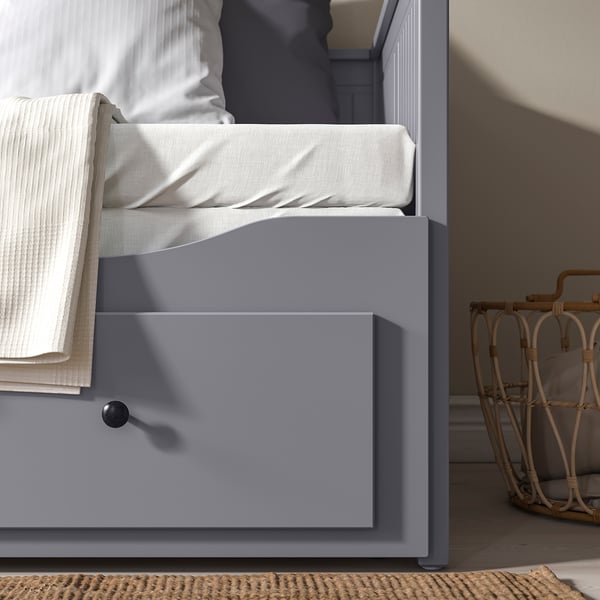 Grey day-bed with mattresses; converts to double bed, offers storage below.