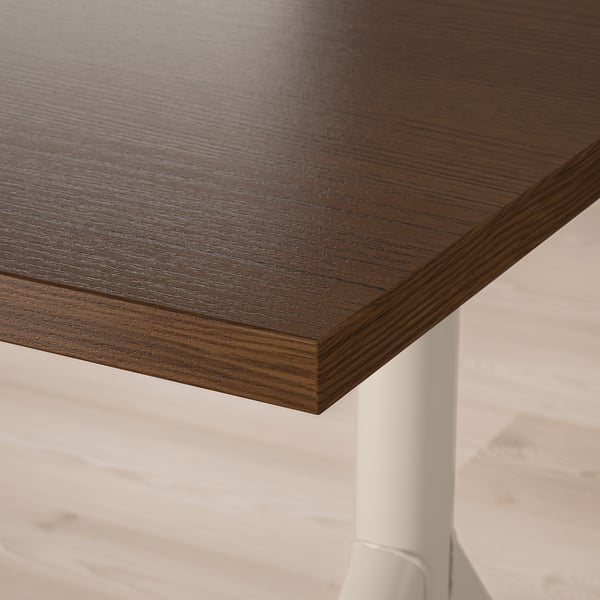 Wooden tabletop with smooth grain and durable edge. Supported by a white metal leg.
