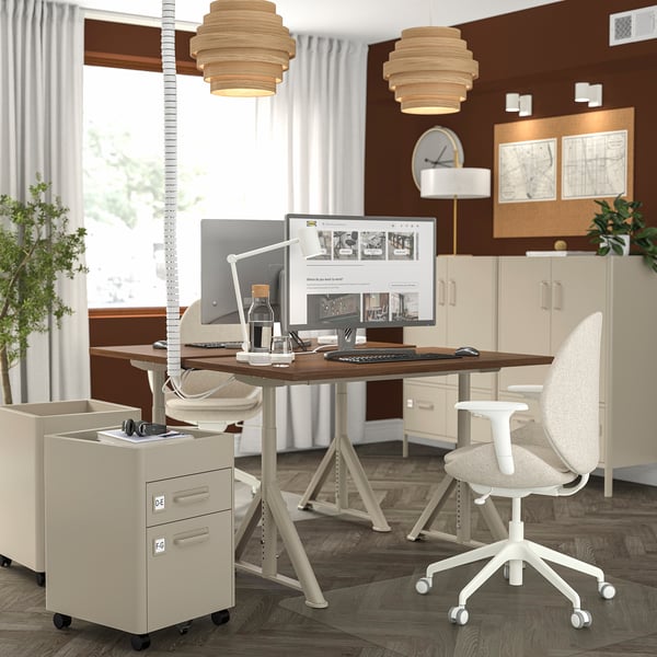 Ergonomic IDÅSEN standing desk with lockable file cabinet, pendant lights, and cable management.