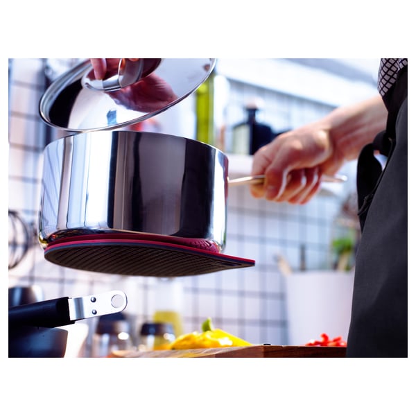 Person lifts pots using magnetic holder. Pots rest on IKEA 365+ GUNSTIG stand. Kitchen setting visible.